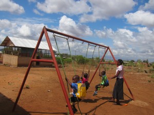 Lilian pushes her students on the swings during play time at Comfort Women's Center