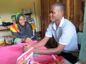 Samweli Daudi with a coworker at his placement site UWAWAYAKI in Moshi, Tanzania. 