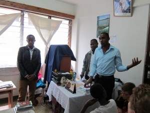 Laurent (right) speaks to a group of visitors at the KIVINET office in Moshi. 